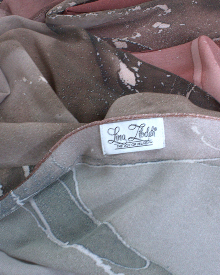 Close-up texture of Mocha and Spice soft luxury chiffon fabric with dual tone muted brown print