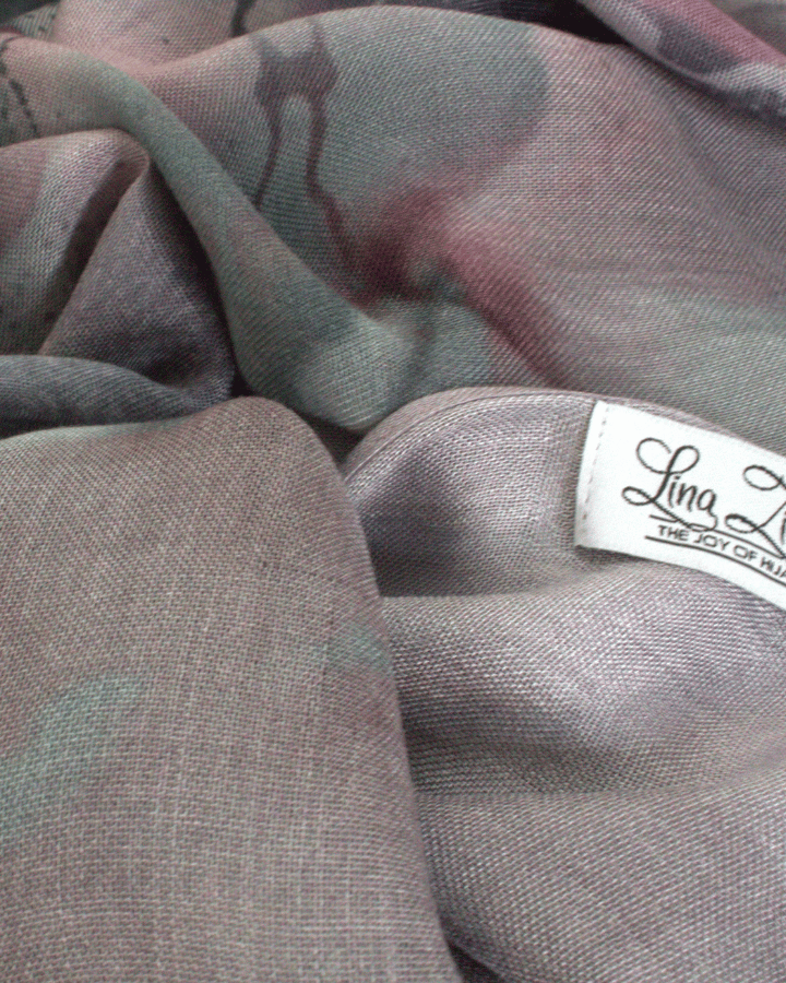 Close-up of a fabric with a visible brand label on a gray background