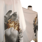 Elegant Hijab scarf with golden, black, and silver painted flowers on a soft white background. Ideal for Muslim formal occasions and work | Lina Zibdeh
