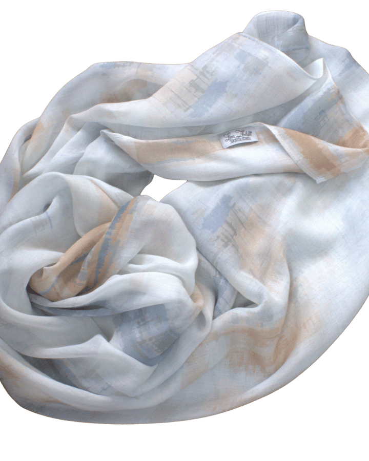 Flat lay of Coastal Mocha bamboo modal hijab showing soft airbrushed stripes in mocha beige, denim blue, and white | Lina Zibdeh