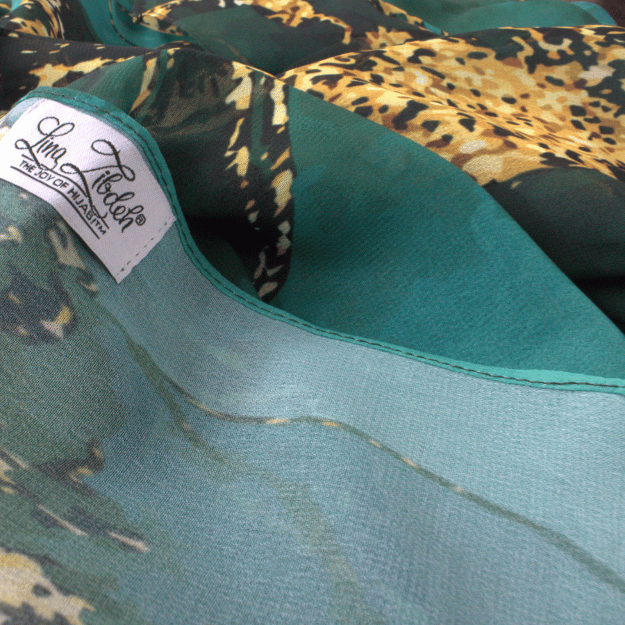 Close-up of premium chiffon fabric highlighting rich emerald color and luxurious texture