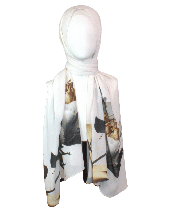 Model wearing a soft white scarf with golden and black floral designs for a sophisticated look.