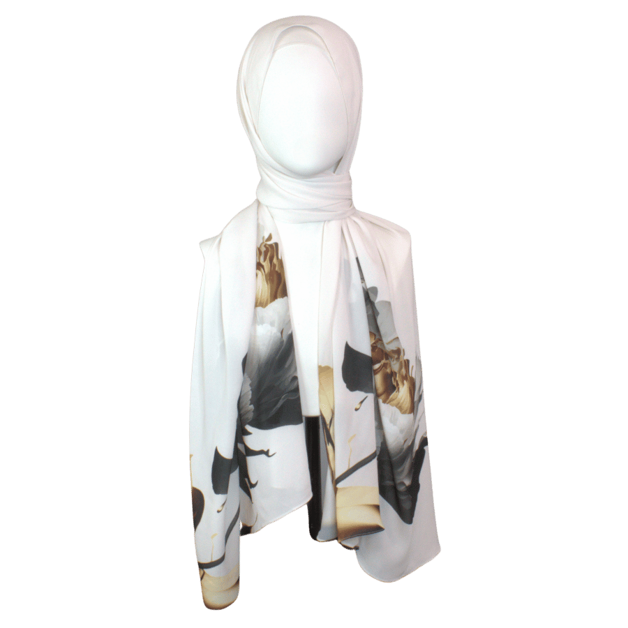 Model wearing a soft white scarf with golden and black floral designs for a sophisticated look.