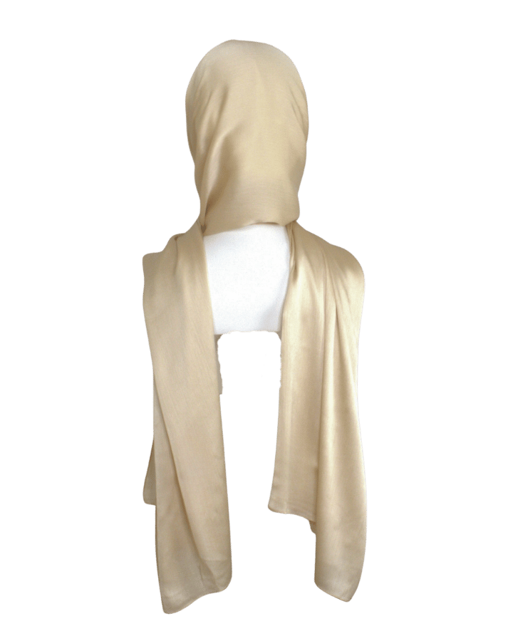 A golden satin crinkle hijab displayed on a mannequin head | Lina Zibdeh