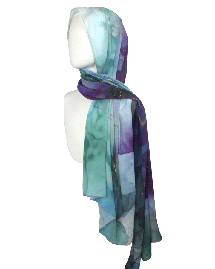 Watercolor jewel-toned chiffon hijab displayed to show soft drape and elegant print.