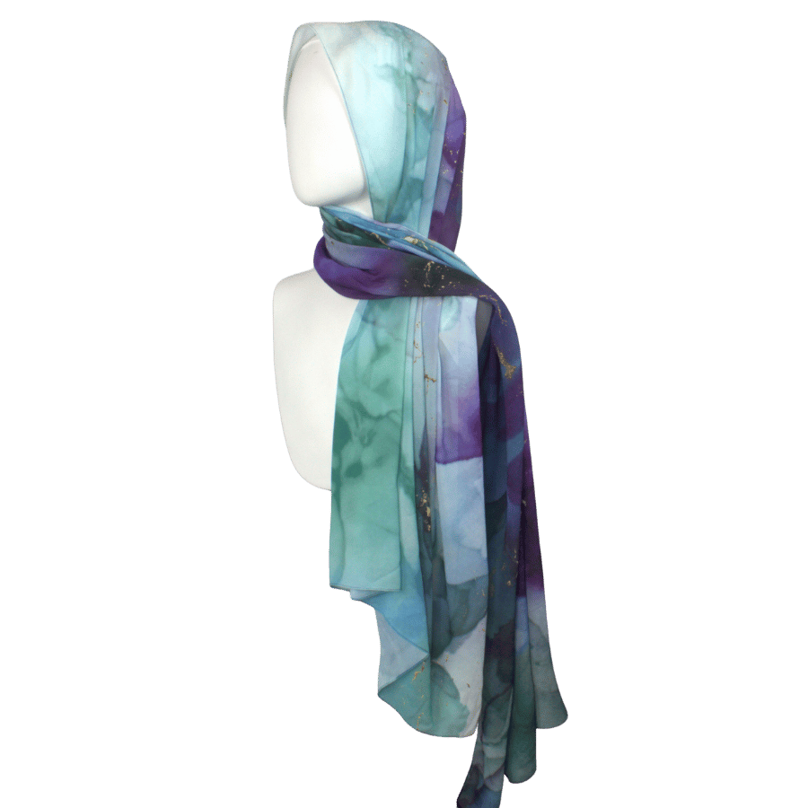 Watercolor jewel-toned chiffon hijab displayed to show soft drape and elegant print.