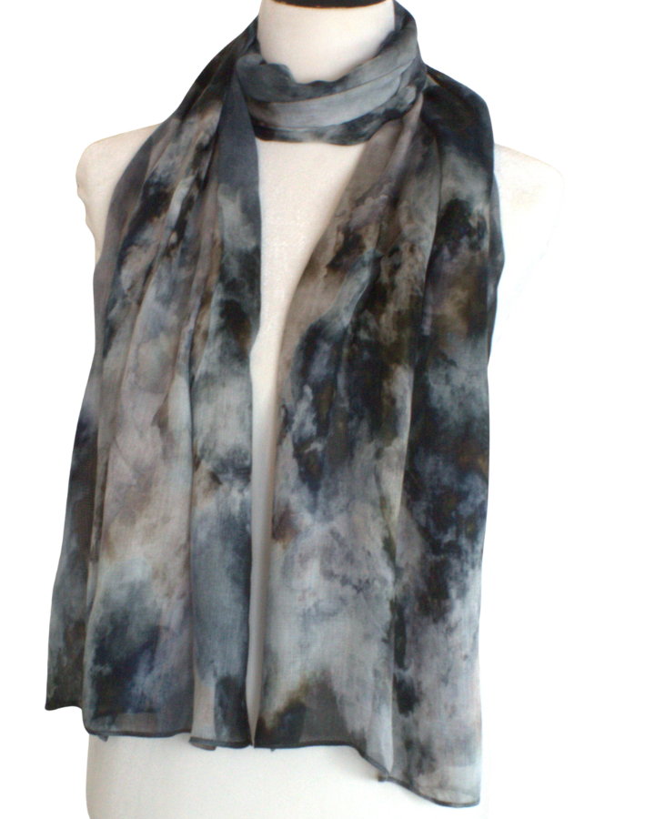 A lightweight hijab scarf with a mottled gray, black, and white tie-dye pattern, draped on a cream-colored mannequin torso against a plain white background.