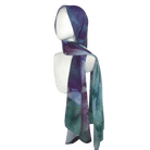 Alt: Designer printed chiffon hijab in blue, green, and purple jewel tones on model.