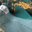 Close-up of premium chiffon fabric highlighting rich emerald color and luxurious texture