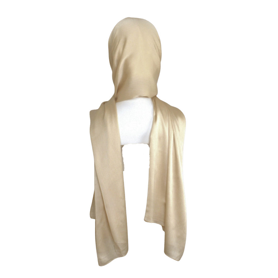 A golden satin crinkle hijab displayed on a mannequin head | Lina Zibdeh