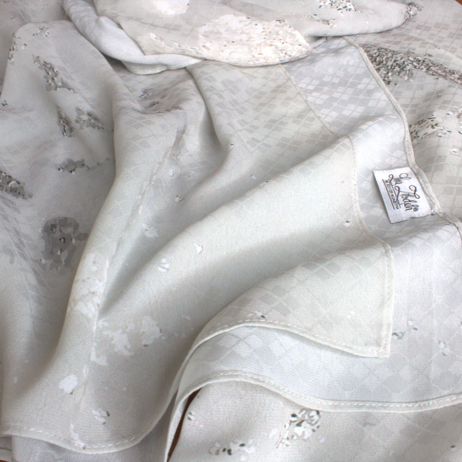 
Fancy silver hijab scarf in textured chiffon with a perfect balance of matte and sheen to it, ideal for special occasions and work. A better grip, soft and easy to wrap. | Lina Zibdeh
