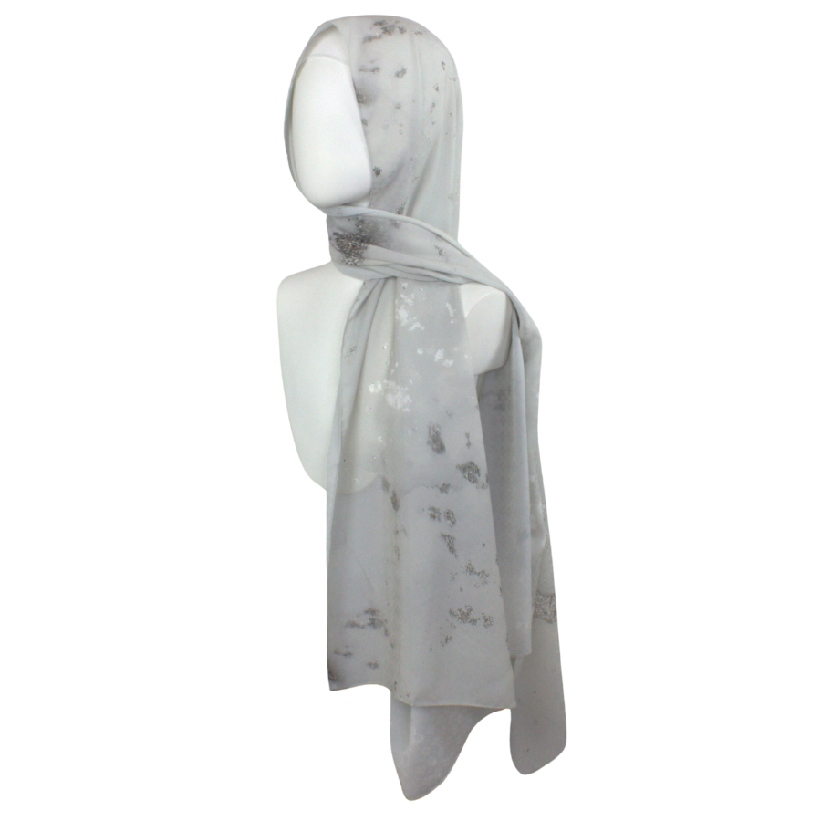 
Designer silver hijab scarf in textured chiffon with a perfect balance of matte and sheen to it, ideal for special occasions and work. A better grip, soft and easy to wrap. | Lina Zibdeh
