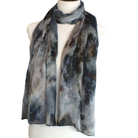 A lightweight hijab scarf with a mottled gray, black, and white tie-dye pattern, draped on a cream-colored mannequin torso against a plain white background.